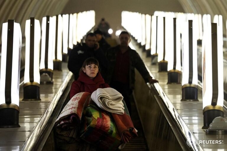 A local resident arrives at a shelter in an underground metro station in Kyiv as