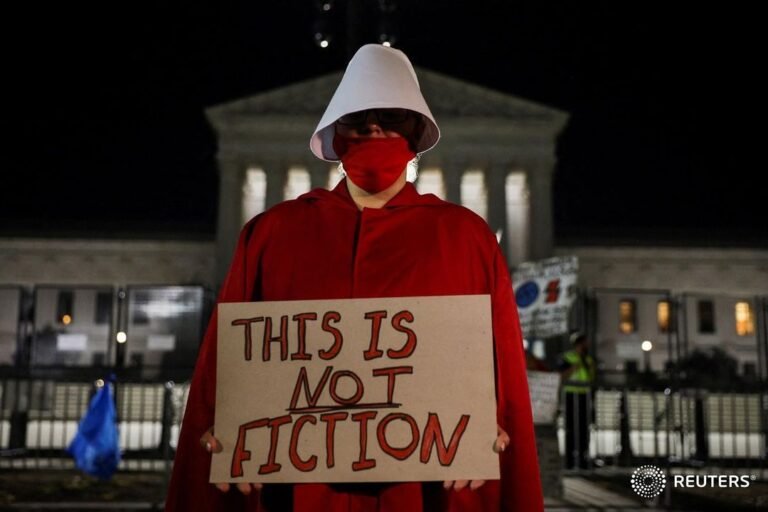 An abortion rights demonstrator dressed in a Handmaid’s Tale costume, protests o