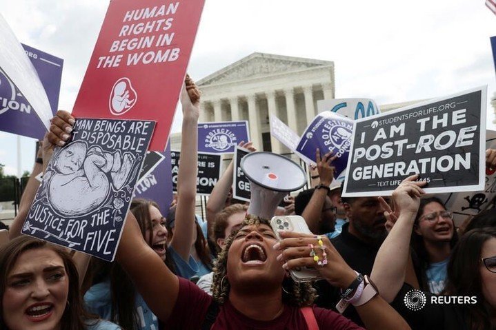 Anti-abortion demonstrators celebrate outside the U.S. Supreme Court as the cour